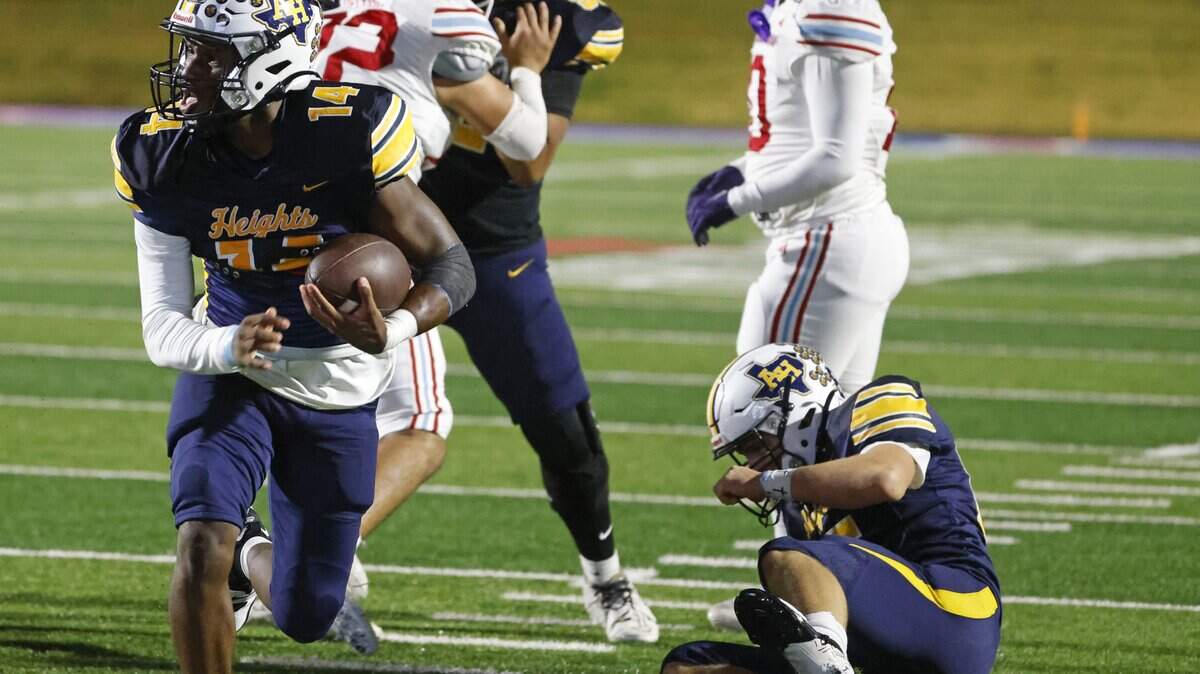 Fort Worth Arlington Heights quarterback Carmelo Carter (14) heads to the end zone for six during the first half of a UIL Class 5A DI area-round football playoff game Thursday Nov. 20, 2025 at Shotwell Stadium in Abilene, Texas.
