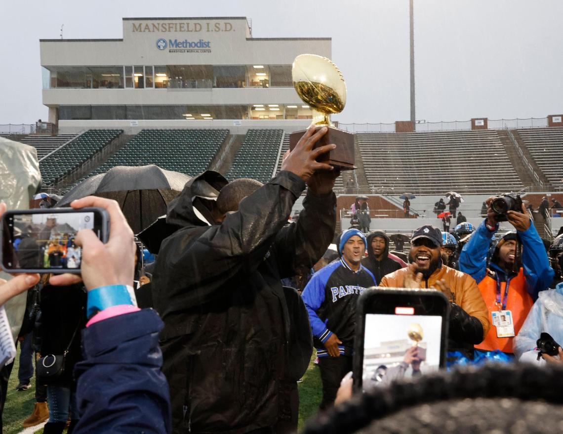 North Crowley head coach Ray Gates displays the trophy after the UIL 6A D1 Quarterfinals at Vernon Newsom Stadium in Mansfield, Texas, Saturday, Dec. 07, 2024.