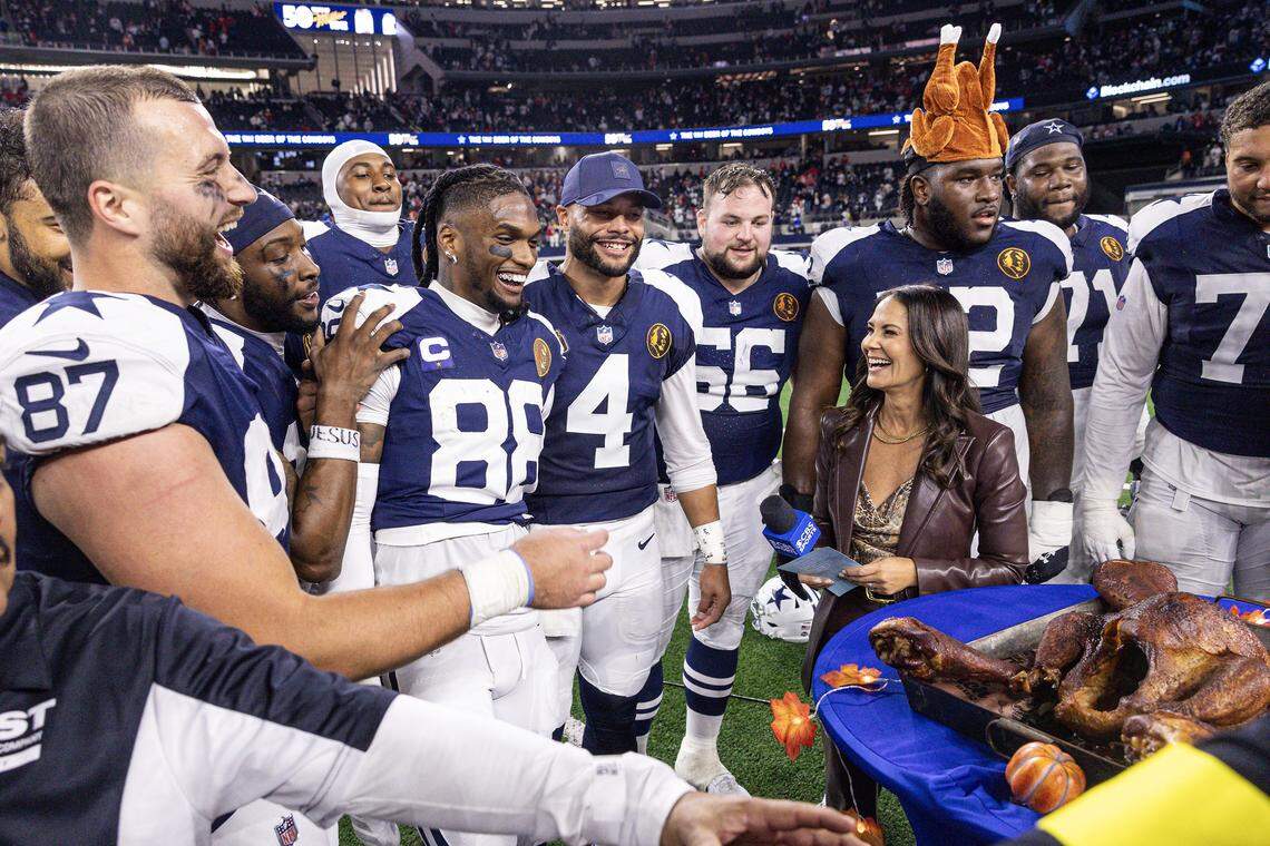 Members of the Cowboys including tight end Jake Ferguson (87), CeeDee Lamb (88), and Dak Prescott (4) celebrated with the ceremonial turkey leg on Thanksgiving  after winning an NFL game between the Dallas Cowboys and the Kansas City Chiefs at AT&T Stadium in Arlington on Thursday, Nov. 27, 2025. The Cowboys won 31-28.