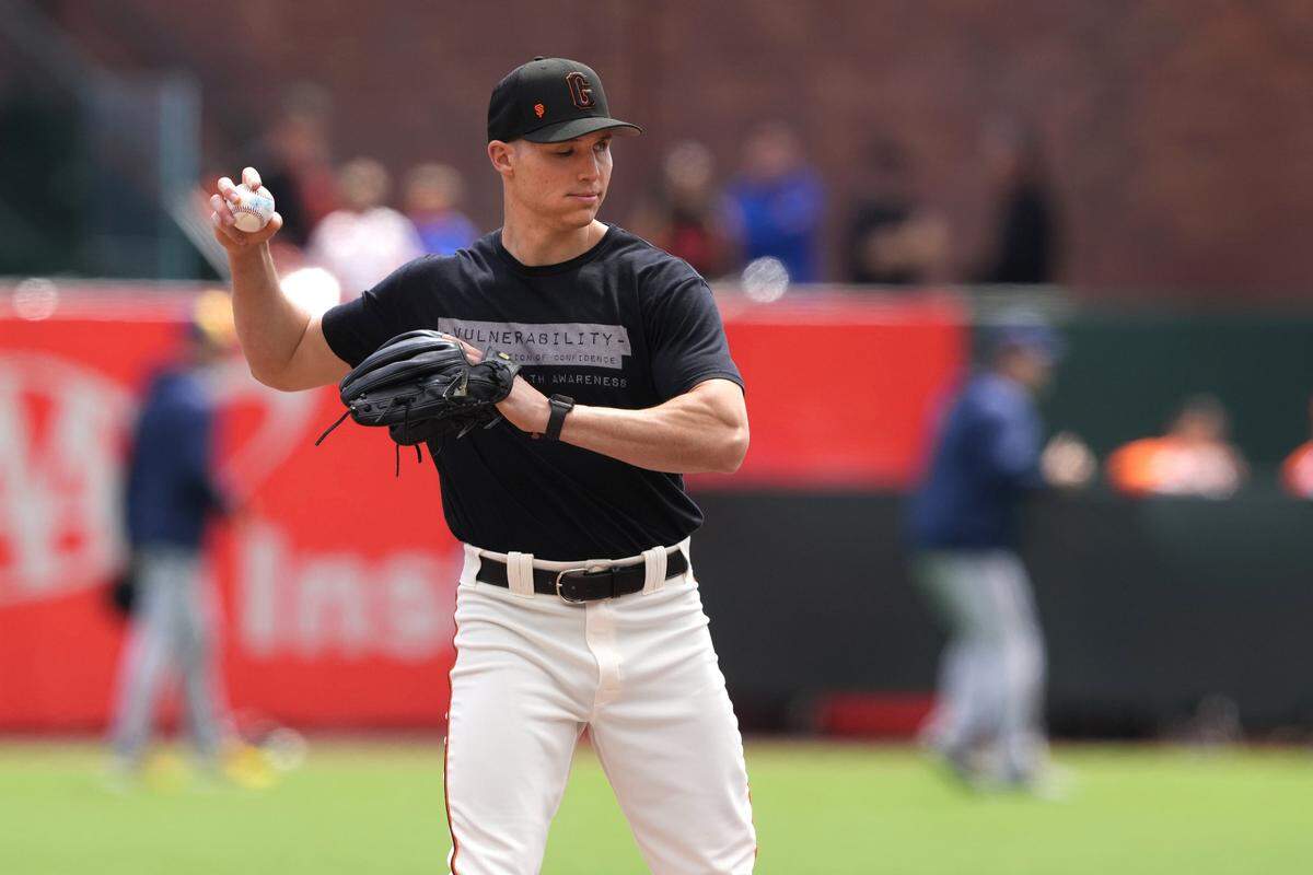 San Francisco Giants mental health advocate Drew Robinson works on the field before the game against the Milwaukee Brewers at Oracle Park.