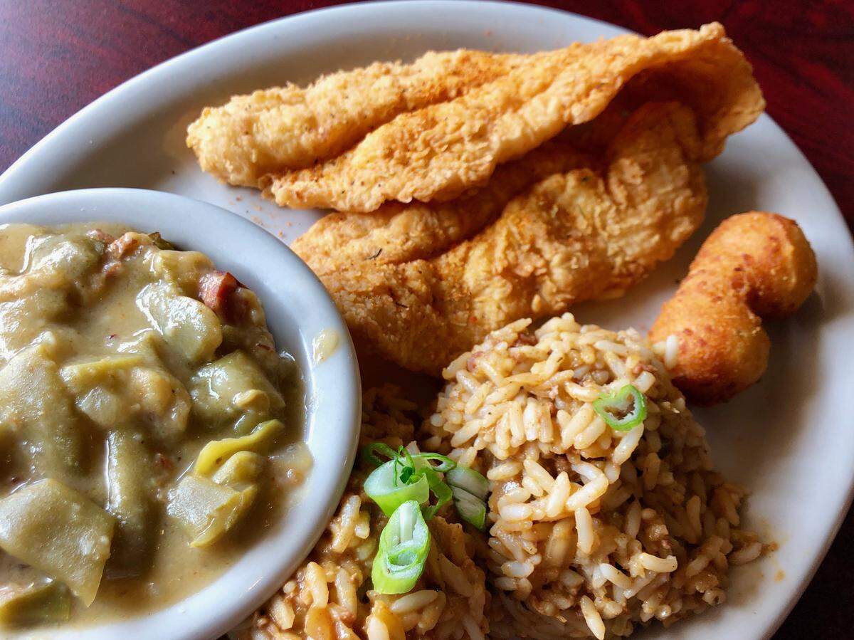 Fried catfish with dirty rice, green beans with ham and hush puppies at Boo-Ray’s of New Orleans.