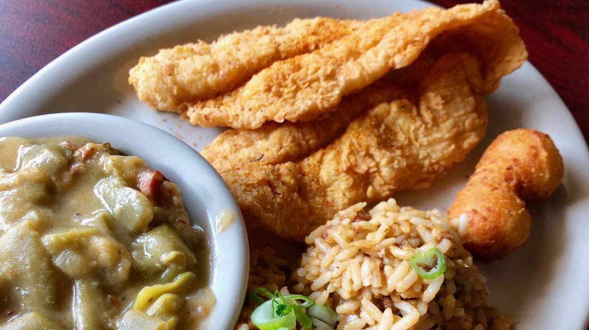 Fried catfish with dirty rice, green beans with ham and hush puppies at Boo-Ray’s of New Orleans.