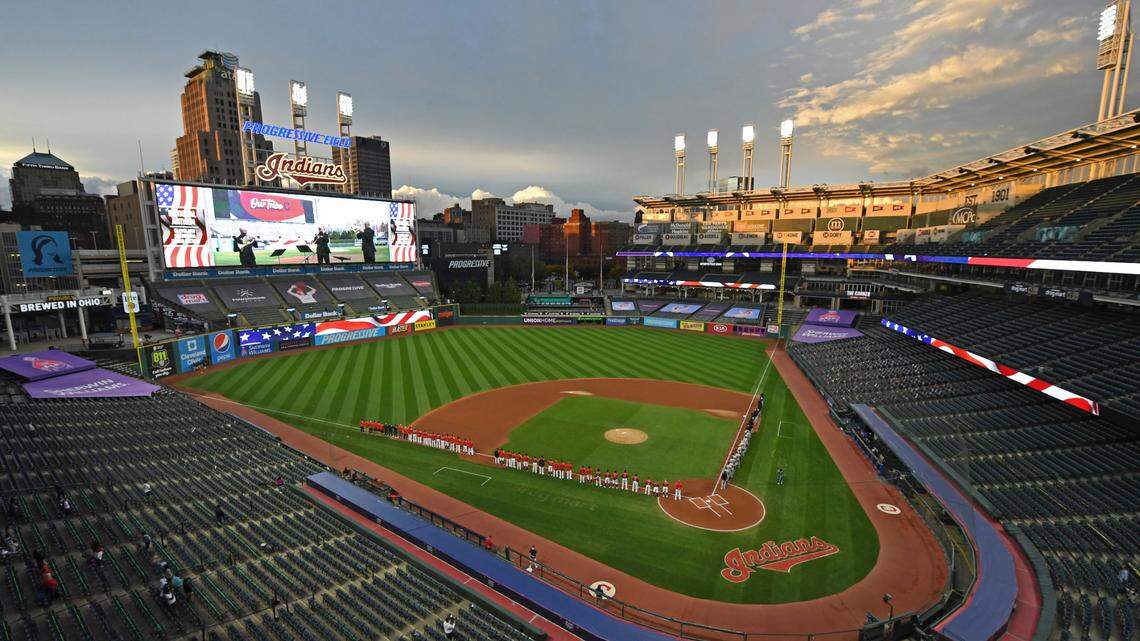 FILE - In this Sept. 29, 2020, file photo, players and coaches for the New York Yankees and the Cleveland Indians stand for the national anthem before Game 1 of an American League wild-card baseball series in Cleveland. (AP Photo/David Dermer, File)