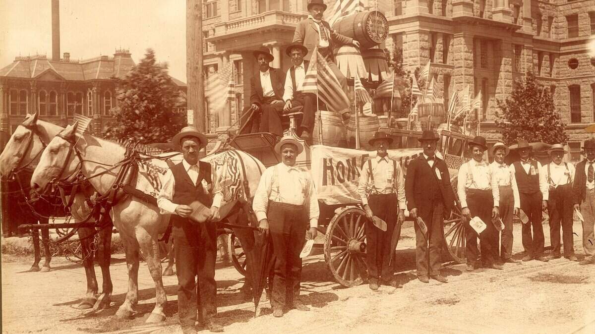 Circa 1899-1902: Labor Day parade in front of Tarrant County Courthouse. Cooper Co.’s float drawn by horse and buggy; Edwin Perry Barclay on float.