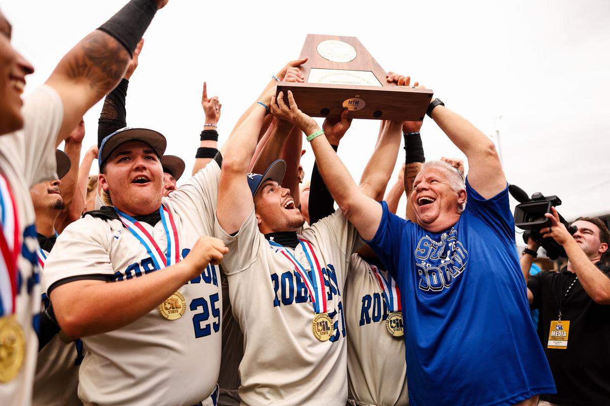 Robinson players celebrate by hoisting the championship trophy after defeating Brock 3-1 in the UIL Class 4A Division II baseball state championship game on Friday, June 5, 2026, at Dell Diamond in Round Rock, Texas.