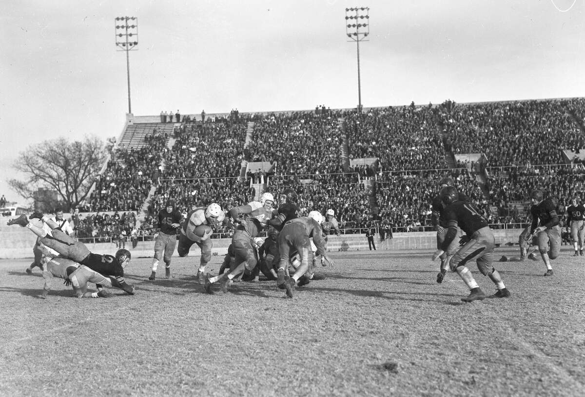 The Masonic Home’s Mighty Mites (white helmets) pulled off a 7-6 victory against the Polytechnic High School Parrots to clinch the district title at Farrington Field on Thanksgiving Day, 1940.