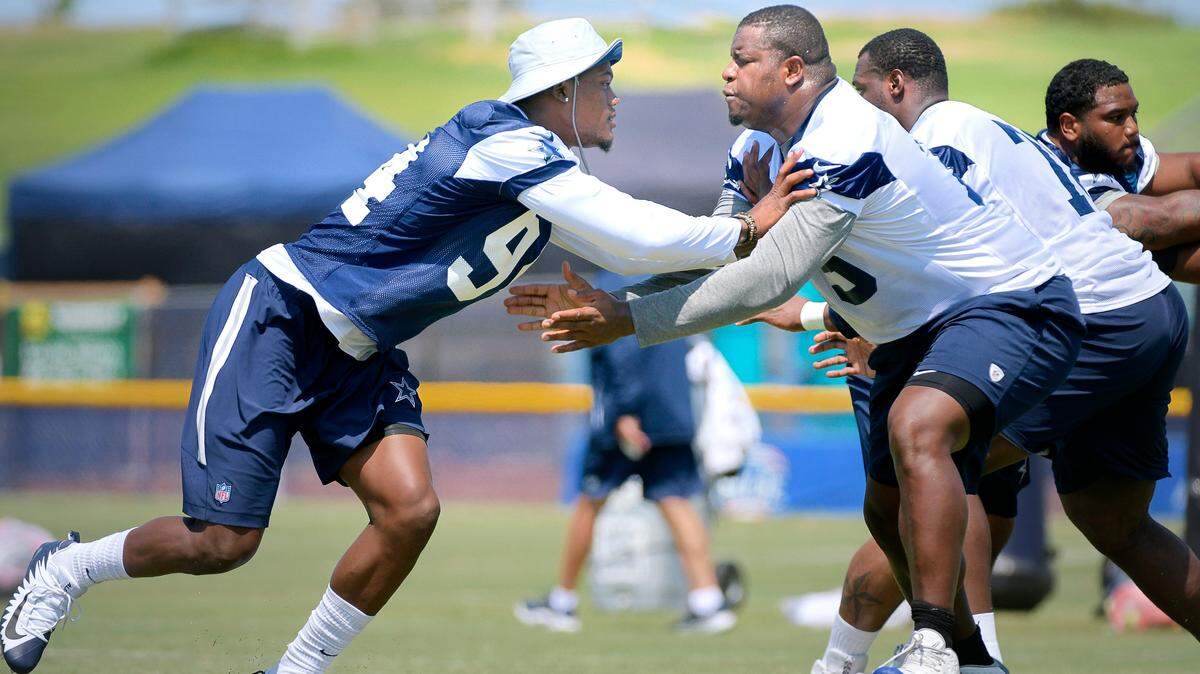 Cowboys defensive end Randy Gregory, left, takes on offensive tackle Cameron Fleming during the morning walk through at training camp in Oxnard, Calif., on Tuesday.  This is the first time Gregory practice with the team at the training camp.