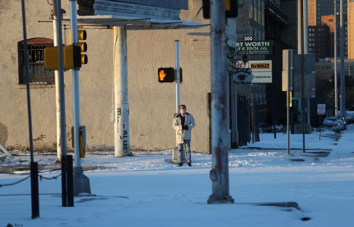 The sun sets on another cold and snowy day in Fort Worth on Feb. 15, 2021.
