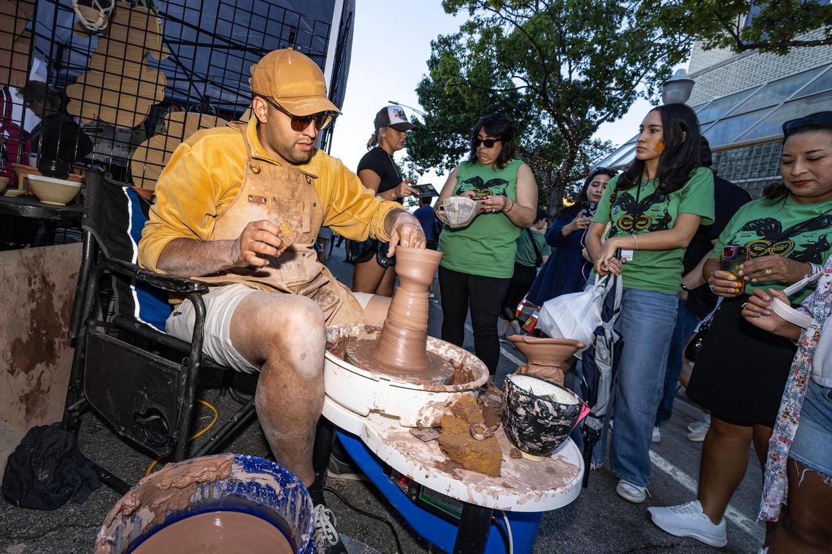 Stephen Salter molds pottery with clay for the crowd around him during the Arts Goggle event on Magnolia Avenue in Fort Worth on Saturday, Oct. 19, 2024.