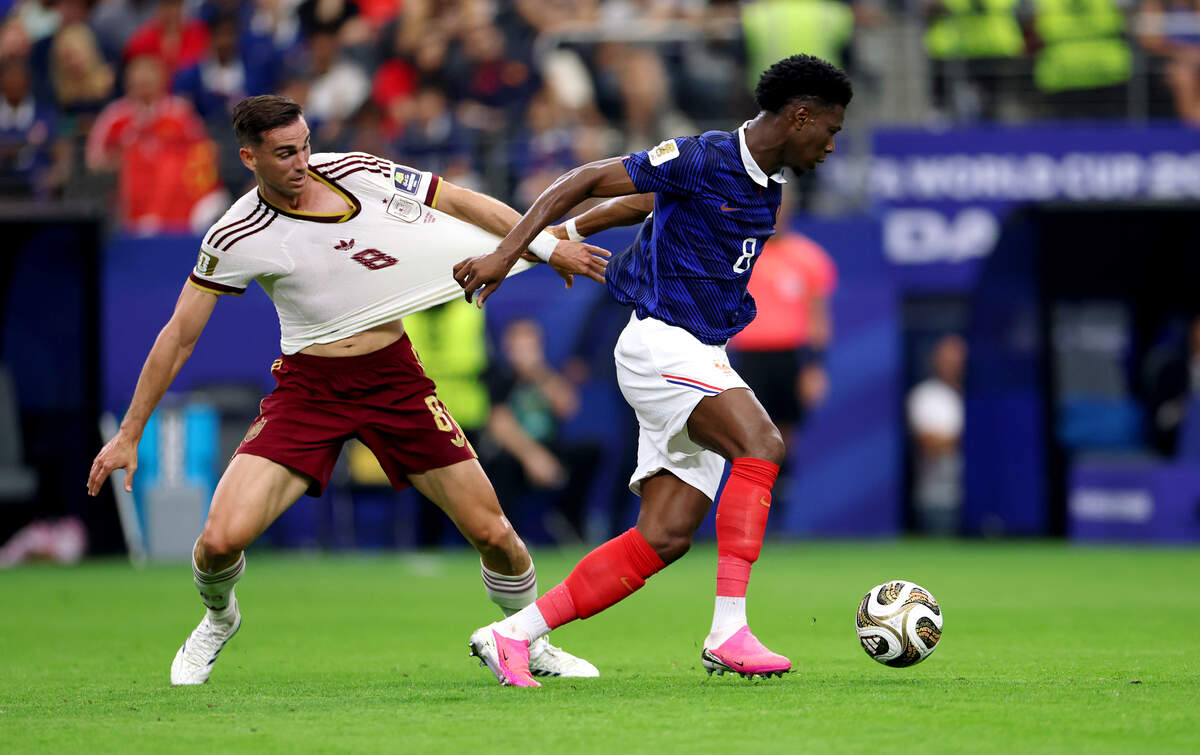 Spain midfielder Fabian Ruiz (8) and France midfielder Aurelien Tchouameni compete for possession during the 2026 FIFA World Cup semifinal on Tuesday, July 14, 2026, at Dallas Stadium in Arlington.