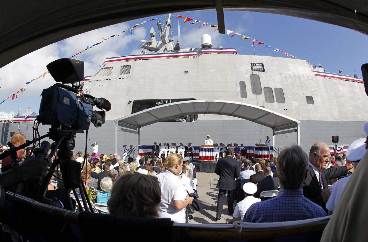 Guests and media crowd into Pier 21 for the commissioning ceremony for the USS Fort Worth in Galveston, Texas.