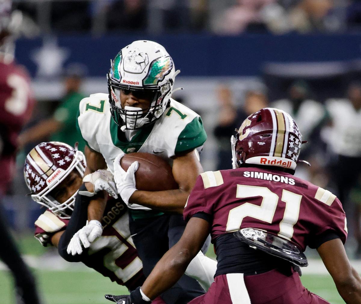 DeSoto wide receiver Antonio Pride is sandwiched between Summer Creek strong safety Qwest Simmons and William Hill after a catch during the second half of the UIL Conference 6A Division 2 state championship football game at AT&T Stadium in Arlington, Texas, Saturday, Dec. 16, 2023.
