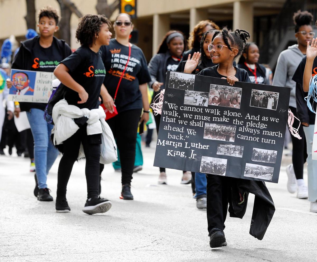 Children and teens walking in the MLK Day parade on Monday.