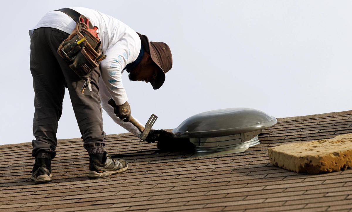 Julio Rodriquez with Focus Contracting Services replaces shingles on a home covered by an insurance claim on Wednesday, March 26, 2025, in Keller.