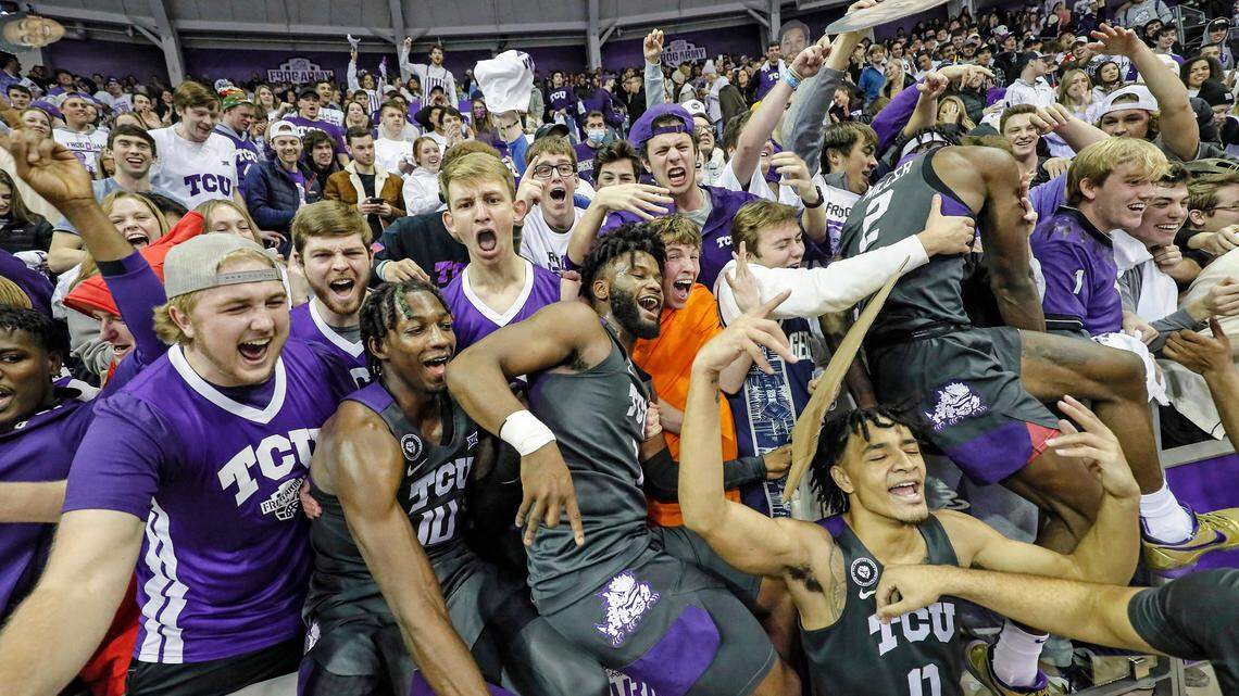 TCU basketball celebrates its overtime victory over Oklahoma on Saturday afternoon. TCU had a record number of students attend the game at Schollmaier Arena.