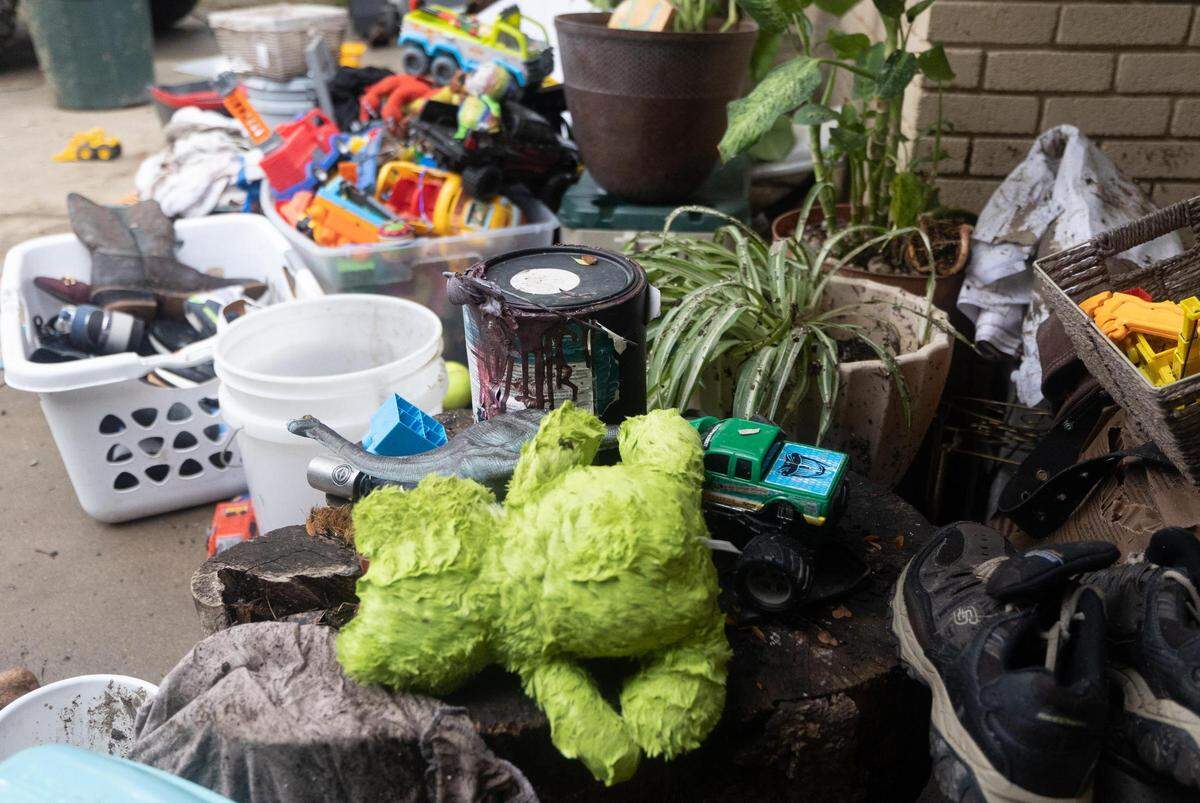Cecilia Perez clears out items from her flooded home on Tuesday, Aug. 23, 2022, in Haltom City. The area received more than 9 inches of rain starting Sunday night.