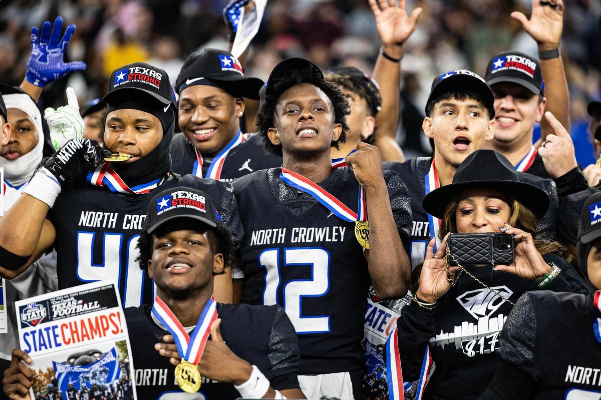 North Crowley quarterback Chris Jimerson (12) and his teammates celebrate after winning the UIL 6A Division I state championship game against Austin Westlake at AT&T Stadium in Arlington on Saturday, Dec. 21, 2024.