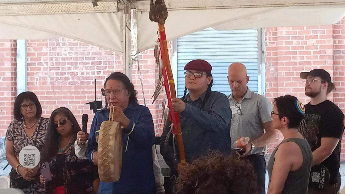 Leslie and Benjamin Thunderhawk recite a Lakota Four Directions Blessing Song at the blessing ceremony for construction of the Fred Rouse Center for Arts and Community Healing on Saturday afternoon.