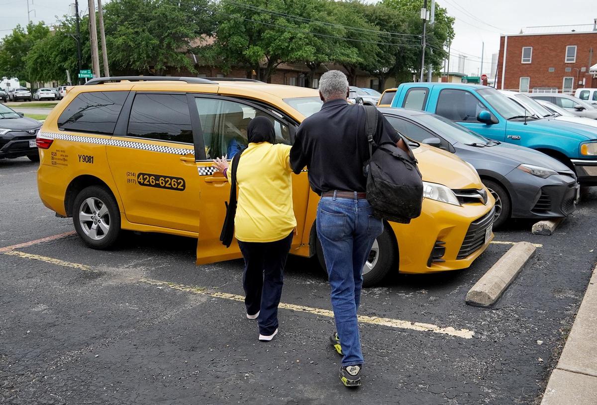 An Access driver guides a visually impaired man into a minivan parked outside Lighthouse For the Blind in Fort Worth on May 9, 2024. Access is a Trinity Metro ride-share service for the disabled.