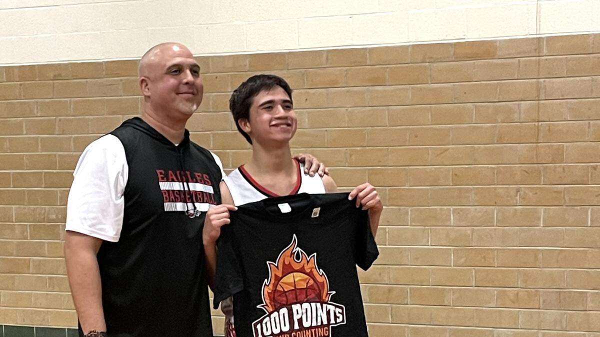 Diamond Hill-Jarvis head coach Anthony Elizondo with his son, also named Anthony, after the younger scored 1,000 points in his high school career. He now has over 2,200 and counting as a senior as the program is turning around from no wins in back-to-back seasons before their arrival in 2023.