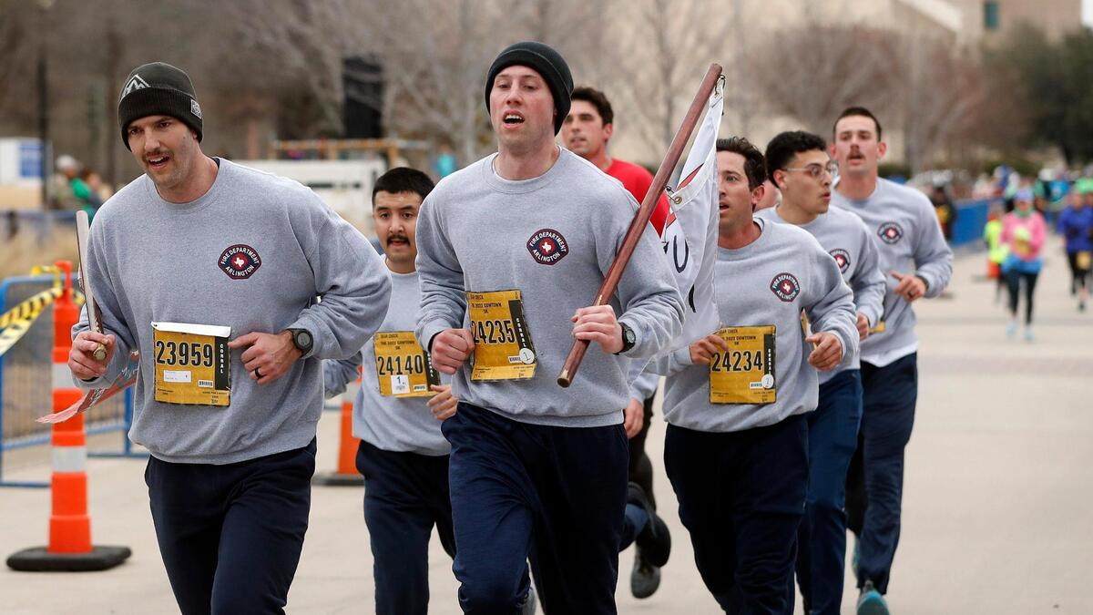 Members of the Arlington Fire Department run during the 44th annual running of The Cowtown at Will Rogers Memorial Center in Fort Worth, Texas, Saturday, Feb. 26, 2022. The team finished in the 26:02 range. 