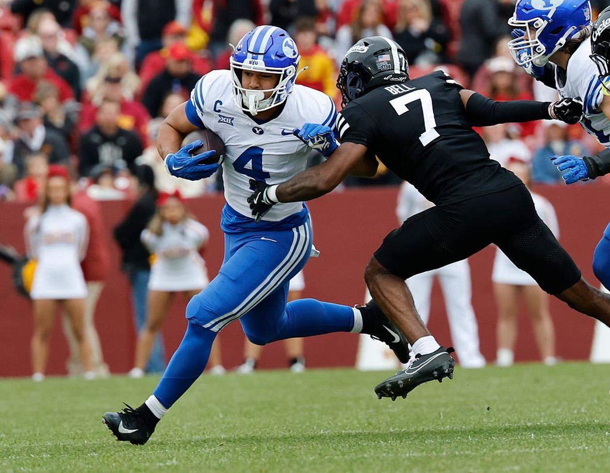 AMES, IA - OCTOBER 25: Running back LJ Martin #4 of the BYU Cougars is tackled by defensive back Tre Bell #7 of the Iowa State Cyclones as he rushed for yards in the first half of play at Jack Trice Stadium on October 25, 2025, in Ames, Iowa. (Photo by David Purdy/Getty Images)