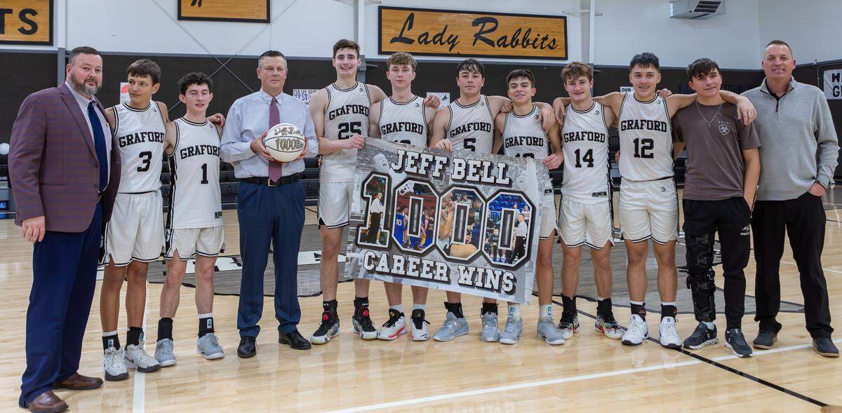 Graford head coach Jeff Bell holds his commemorative “1,000-win” basketball with assistant coach Steven Stegall (left) and the rest of his Jackrabbit team. Bell’s 1,000th win came with a 90-34 win over the De Leon Bearcats on Friday, Dec. 20, 2024 at Graford High School. (Photo courtesy of: Jordan Bell)