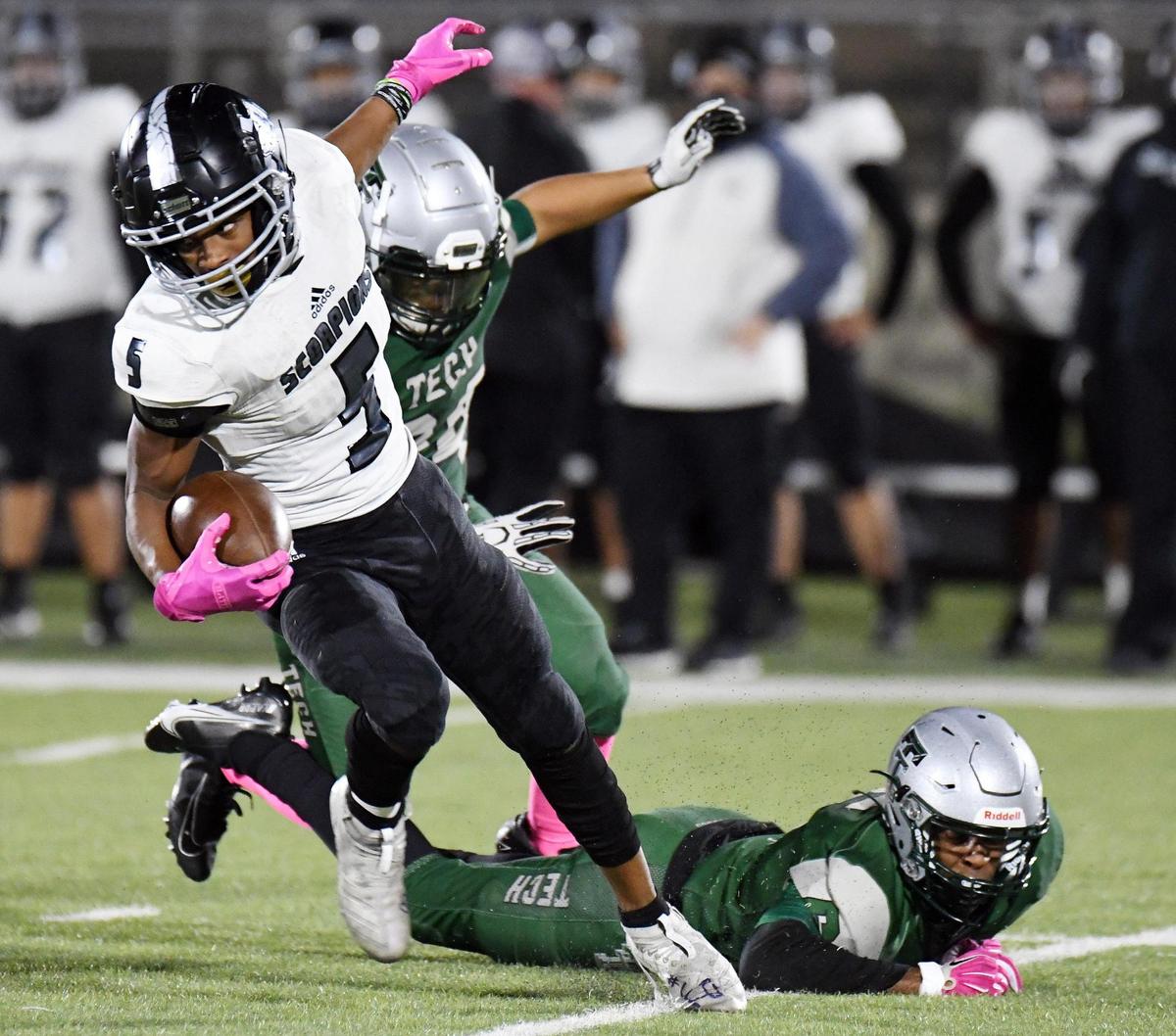 South Hills’s Ethan Smith, left eludes Trimble Tech’s Adrian Guadian, and Deryl Muhammad as he returns a punt in the second quarter of their Division2 District 4-5A football game Thursday, October 29, 2020 at Clark Stadium in Fort Worth, Texas. Special/Bob Haynes
