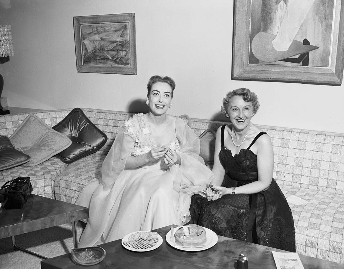 May 30, 1952: “Glamorous Joan Crawford, left, thrilled at being back in her native Texas, enjoys a chat with her hostess, Mrs. E.W. Schenecker, during her visit here.”