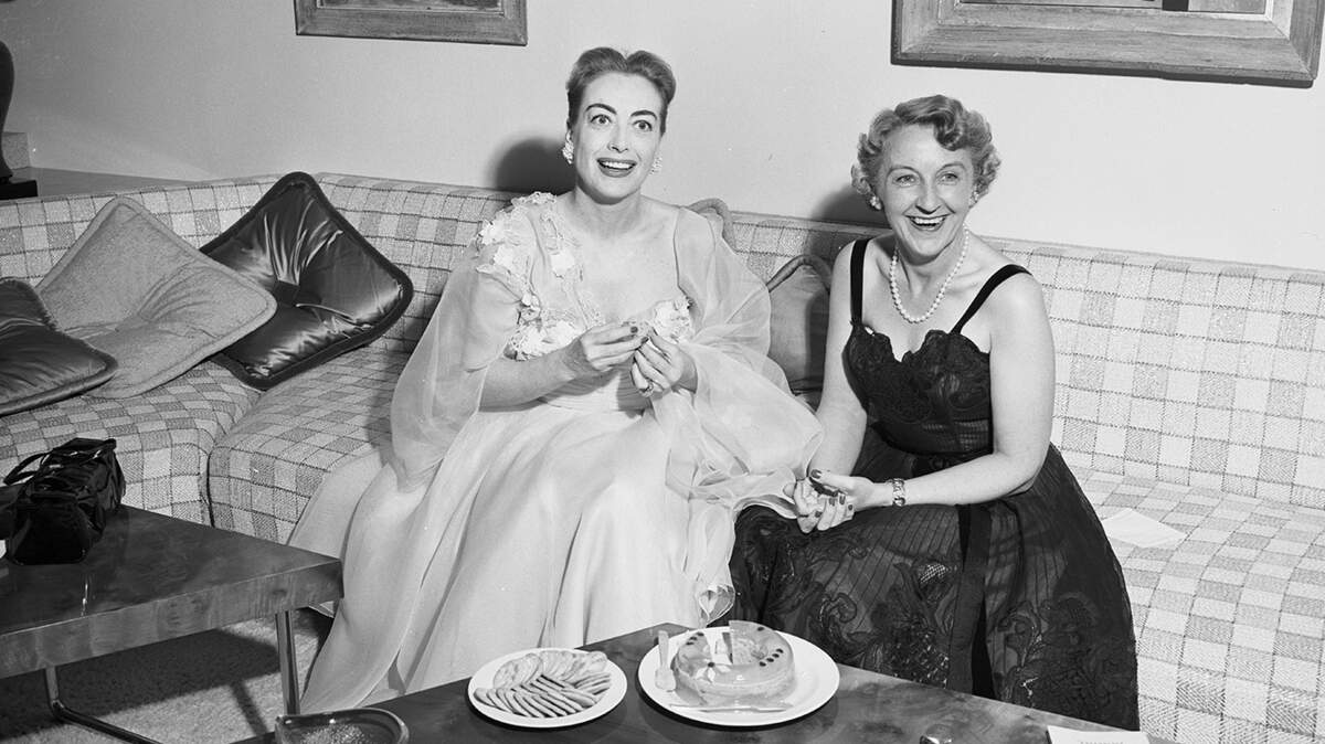 May 30, 1952: “Glamorous Joan Crawford, left, thrilled at being back in her native Texas, enjoys a chat with her hostess, Mrs. E.W. Schenecker, during her visit here.”