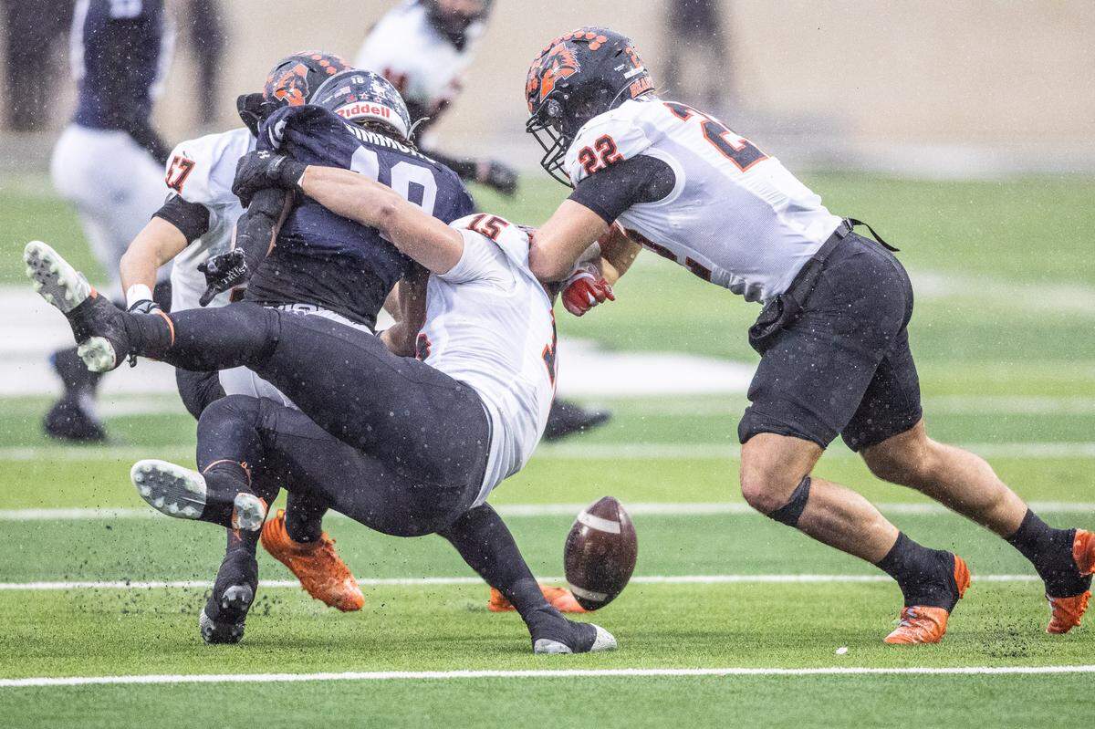 Aledo’s Kutter Harrell (15) makes a hit on Denton Ryan’s Byran Simmons (18) during a kick return to force a fumble that was recovered by Ryan in a Class 5A Division 1 state quarterfinal on Saturday, Dec. 7, 2024 at Crowley ISD Multi-Purpose Stadium in Fort Worth, Texas.
