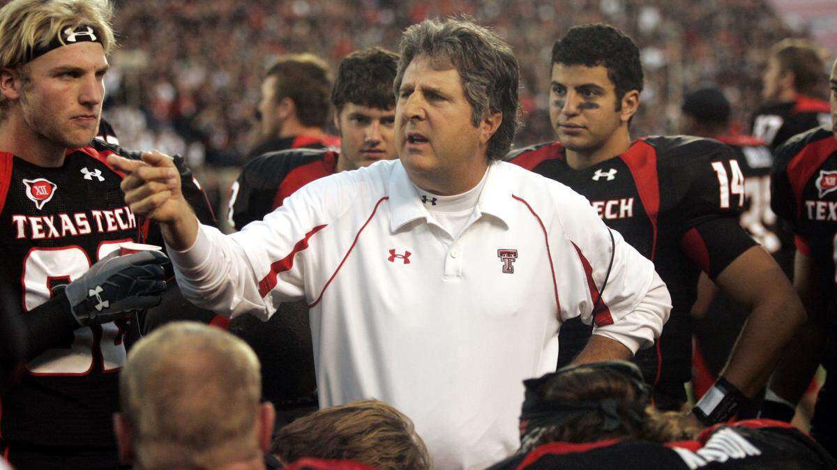 In this Oct. 24, 2009, file photo, Texas Tech coach Mike Leach talks with his team during an NCAA college football game against Texas A&M in Lubbock, Texas.