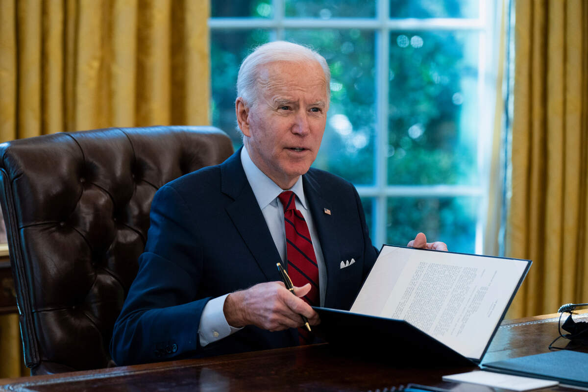 President Joe Biden signs a series of executive orders on health care, in the Oval Office of the White House, Thursday, Jan. 28, 2021, in Washington. (AP Photo/Evan Vucci)