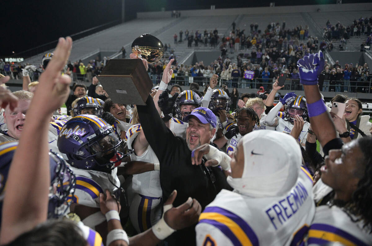 Richardson principal Chris Choat delivers the bi-district trophy to Eagles coaches and players after a UIL playogg football game against Haltom at Birdville ISD FA/AC in North Richland Hills, Texas on Friday, Nov. 15, 2024.