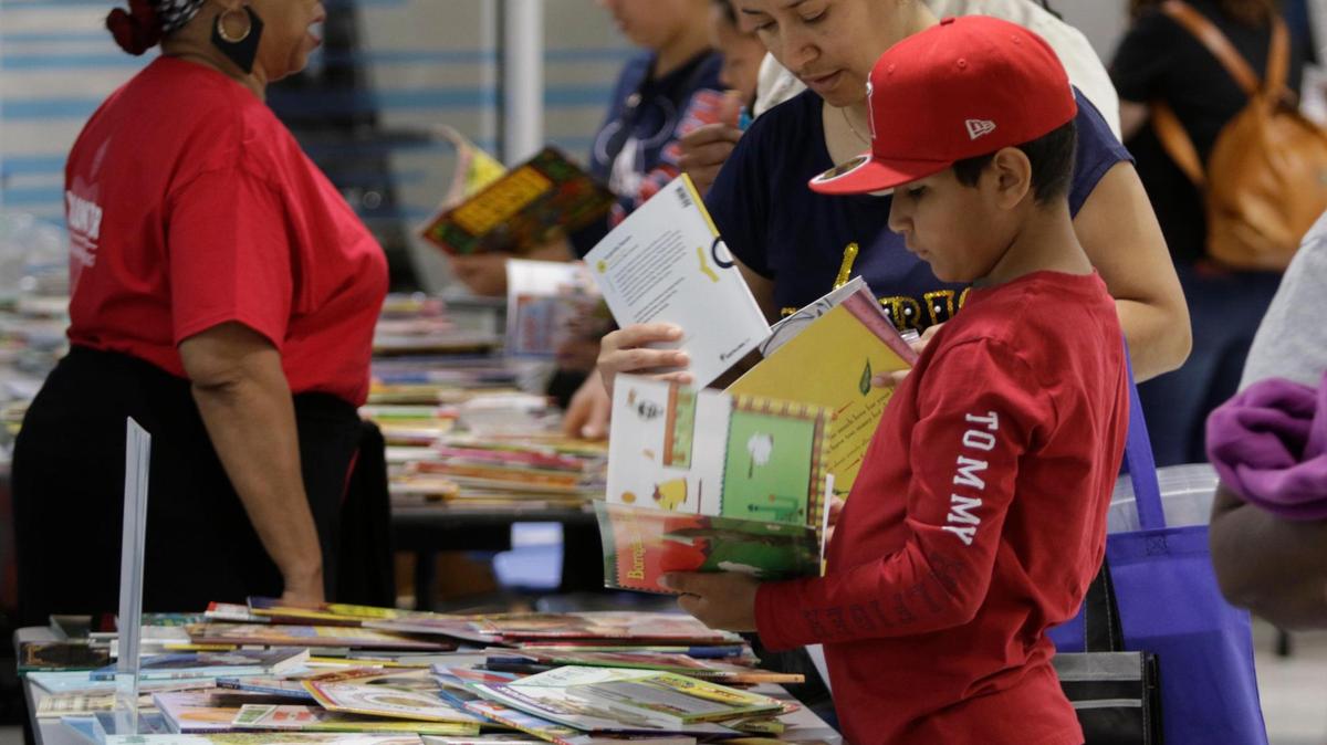 Edwardo Perez, 9, looks over the free books available with his mother Susana Aquiniga during Fort Worth Independent School District’s family literacy conference on Saturday, April 12 at O.D. Wyatt High School.