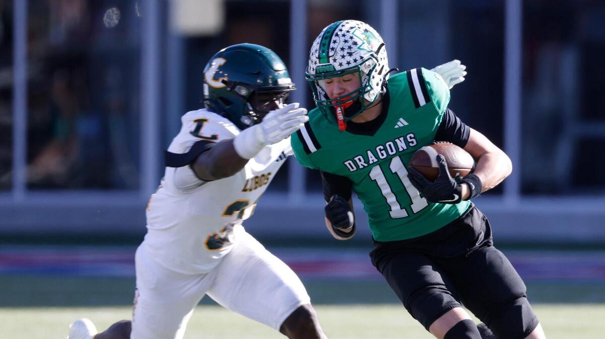 Southlake Carroll wide receiver Brock Boyd (11) escapes a Longview defender during the UIL 6A D2 Semifinals football game at Gerald J. Ford Stadium in University Park, Texas, Saturday, Dec. 14, 2024.