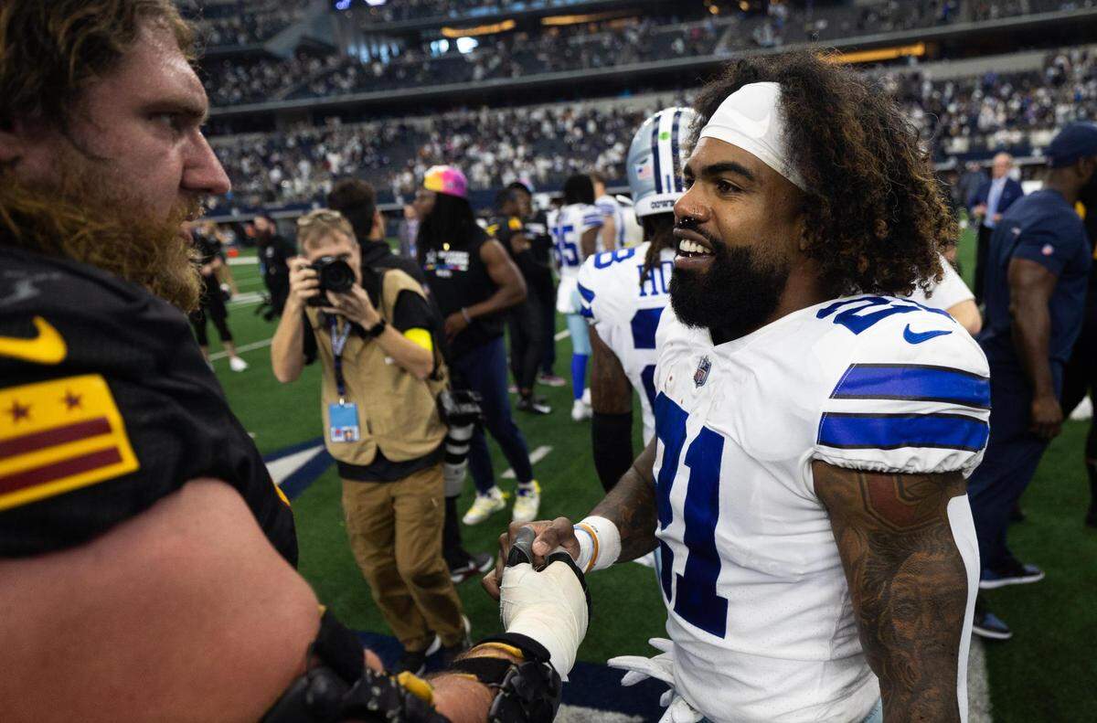 Dallas Cowboys Ezekiel Elliott shakes hands after the game against Washington Commanders on Sunday, Oct. 2, 2022, at AT&T Stadium in Arlington.
