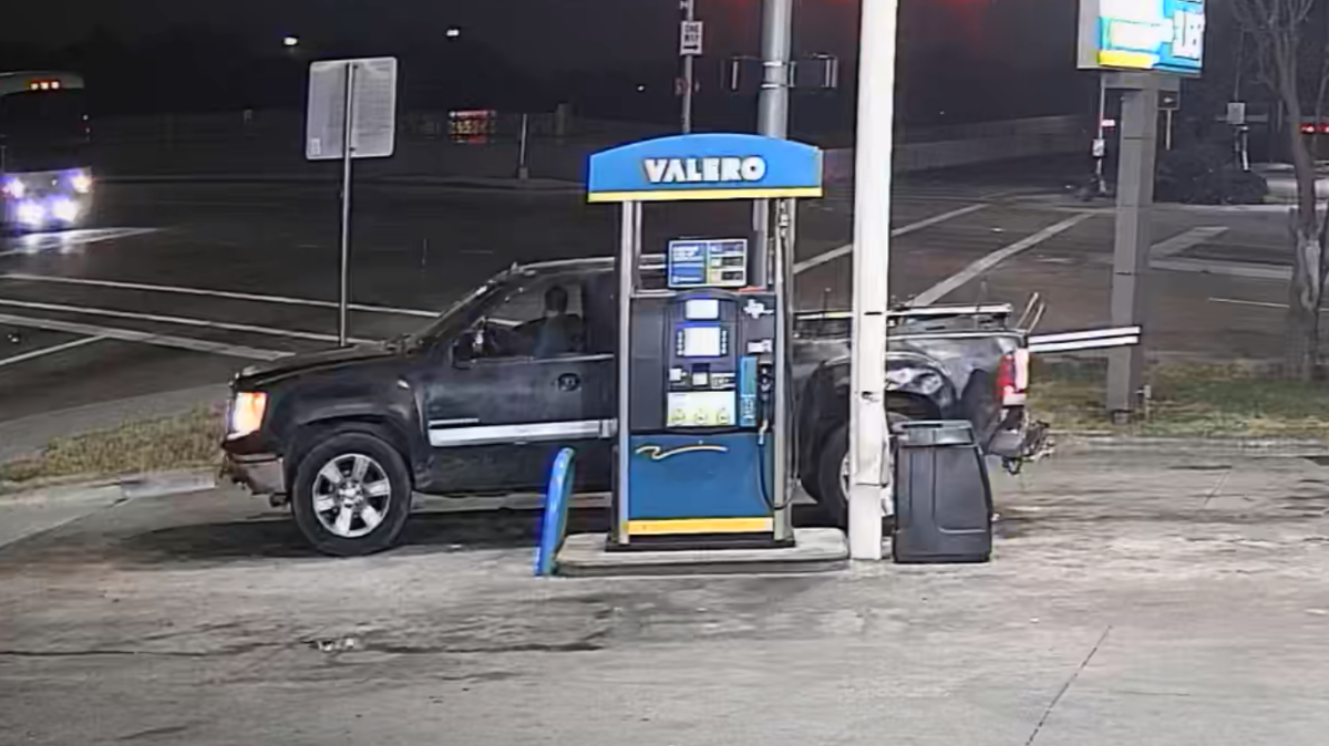 A side view of the suspect and his vehicle, a 2005-2010 GMC pickup truck.