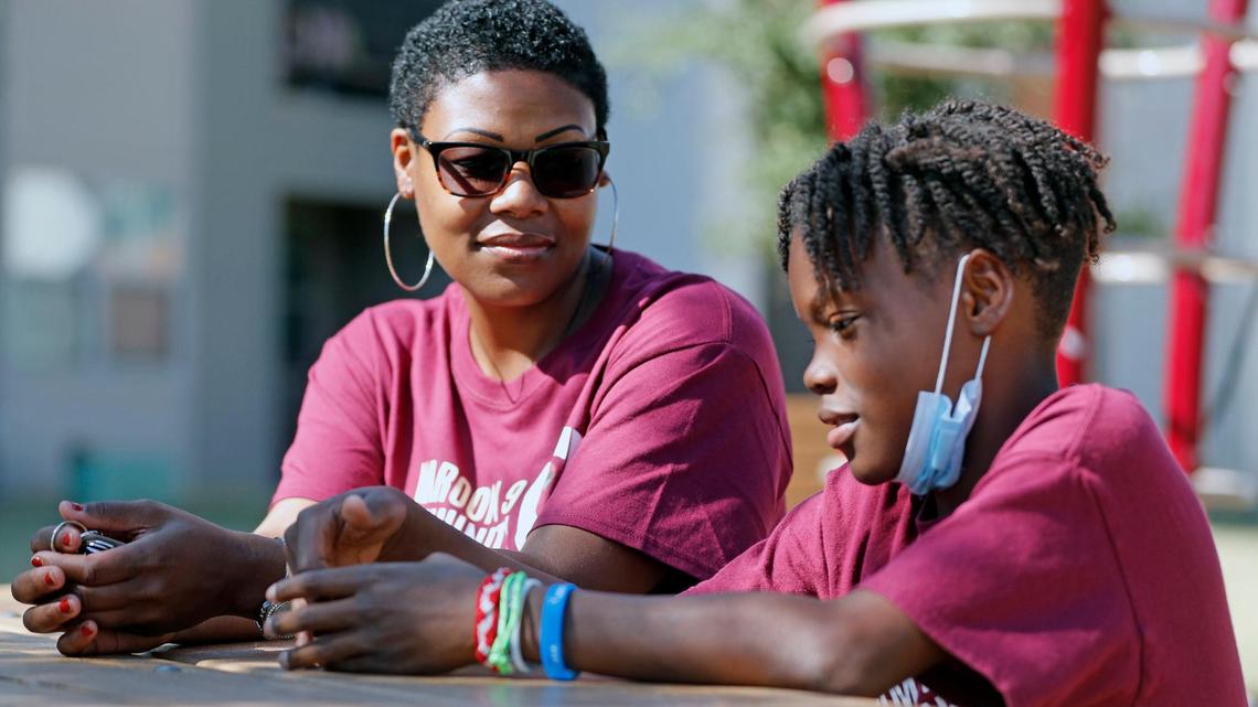 Shane Leonard, 12, and his mother, Latresha, at a playground outside their apartment complex. Shane has sickle cell disease and is unable to participate in any strenuous activities - but he does play a little basketball.