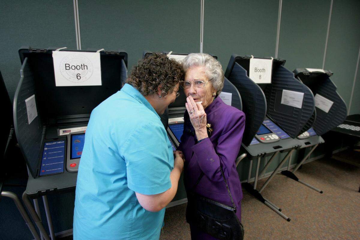 Oct. 22, 2004: Ruth Koberg, who turns 100 on election day, has voted in every election since 1928. Here she shares a bit of life wisdom with election clerk Pam Dildy, who helped her navigate the new touch screen voting system at an early voting location in the YMCA in Benbrook.