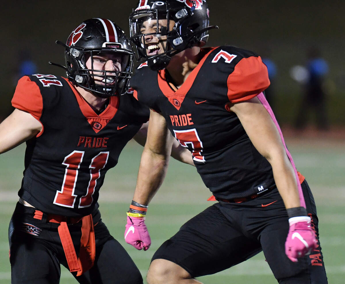 Colleyville Heritage’s Christopher Knight, right, celebrates with teammate Brannan Mannix after stopping Summit quarterback David Hopkins to force a fourth down in the first quarter of their district 4-5A Division 1 football game Friday, October 15, 2021 at Mustang-Panther Stadium in Grapevine, Texas. Heritage went on to win 35-34. Special/Bob Haynes