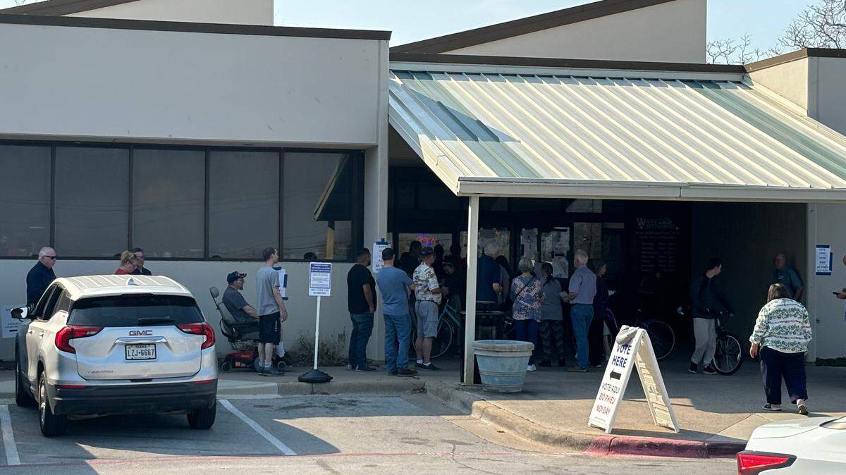 The line to vote in the Republican primary at the polling station at the White Settlement Public Library extends onto the sidewalk outside on primary Election Day on March 5, 2024.