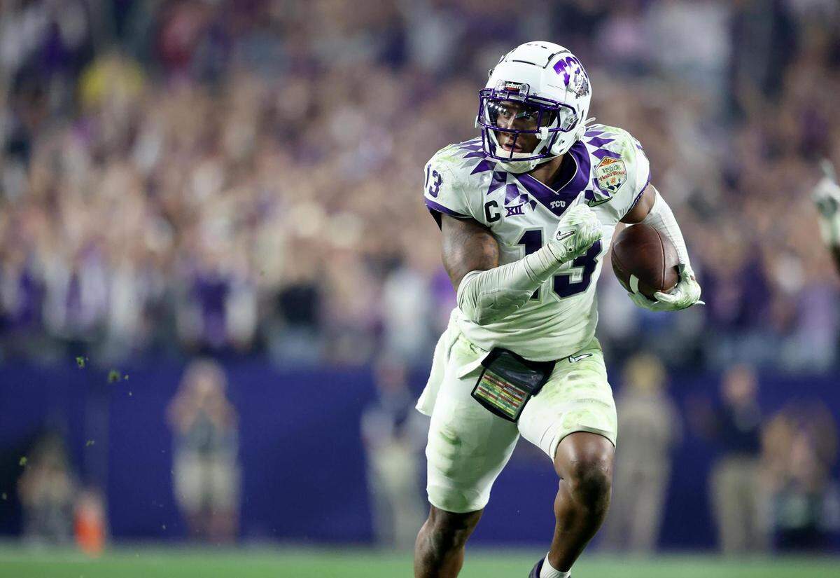 TCU linebacker Dee Winters runs the ball in for a touchdown after an interception against Michigan at the Vrbo Fiesta Bowl at State Farm Stadium in Glendale, Ariz., on Saturday, December 31, 2022.
