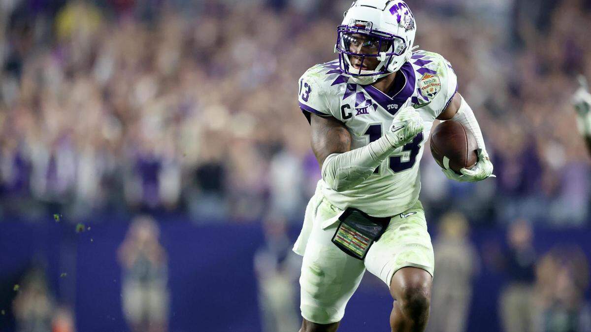 TCU linebacker Dee Winters runs the ball in for a touchdown after an interception against Michigan at the Vrbo Fiesta Bowl at State Farm Stadium in Glendale, Ariz.