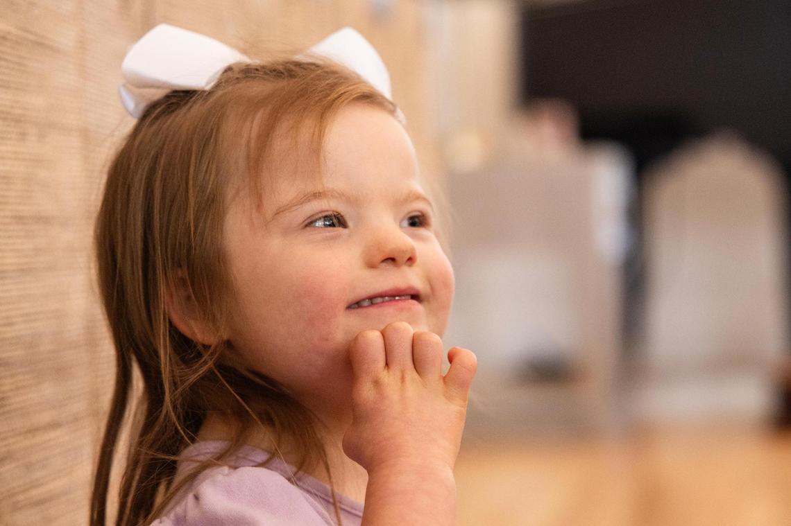 Annie Morey, 4, plays with her family in the living room of their home in Parker County on Friday, March 28. The Morey family has been in a legal battle with Aledo ISD because they oppose an IQ test for Annie, who has Down syndrome, in order to enroll her in school.