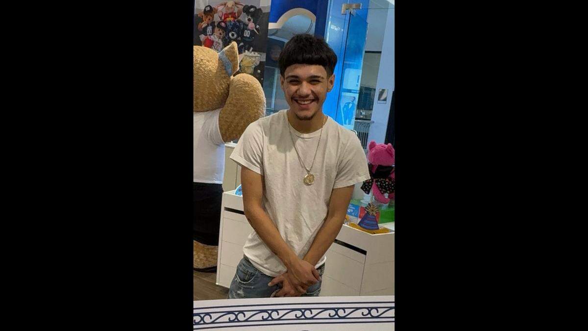 Emiliano is pictured smiling with his hands crossed.