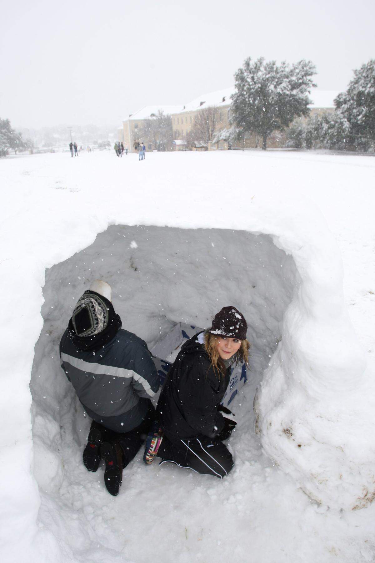 Colby Nichols, left, and TCU soph Alicia Atwood built an igloo on the TCU campus near the Greek dorms on Thursday, Feb. 11, 2010.