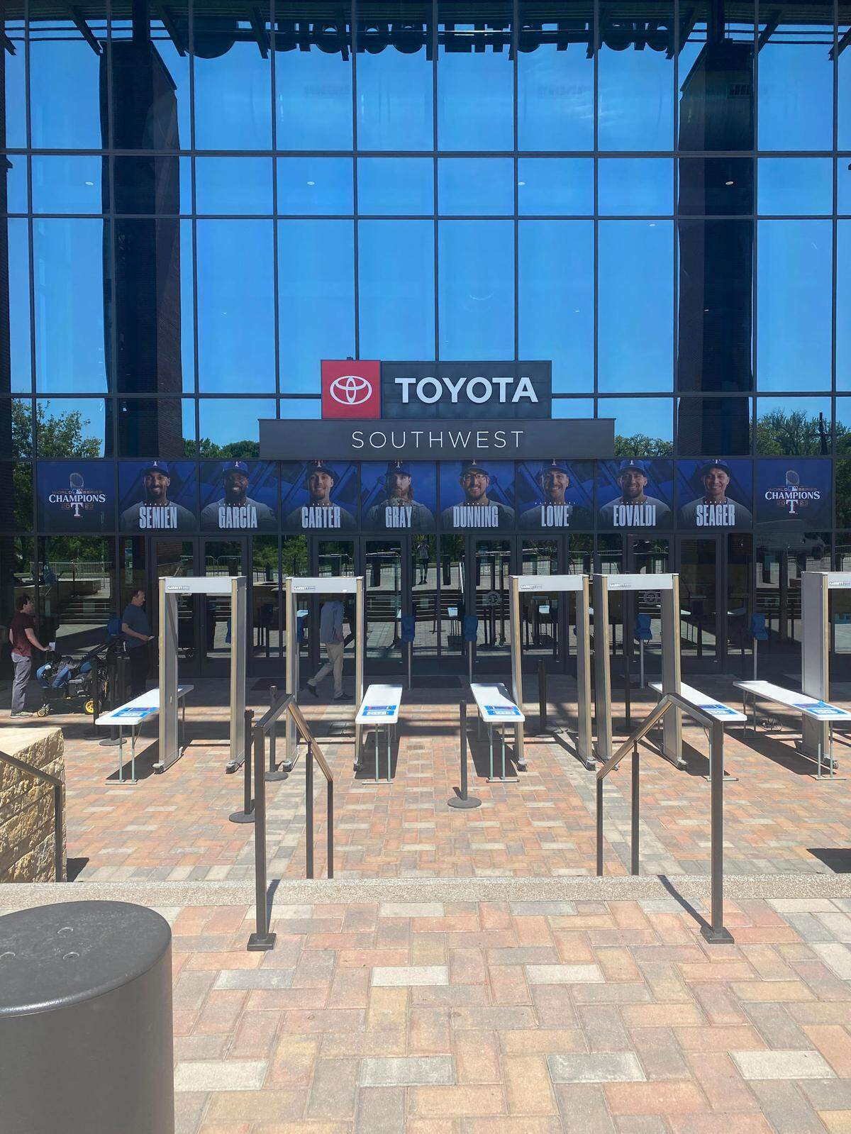 Southwest entrance at Globe Life Field displaying a banner commemorating the 2023 World Series victory.