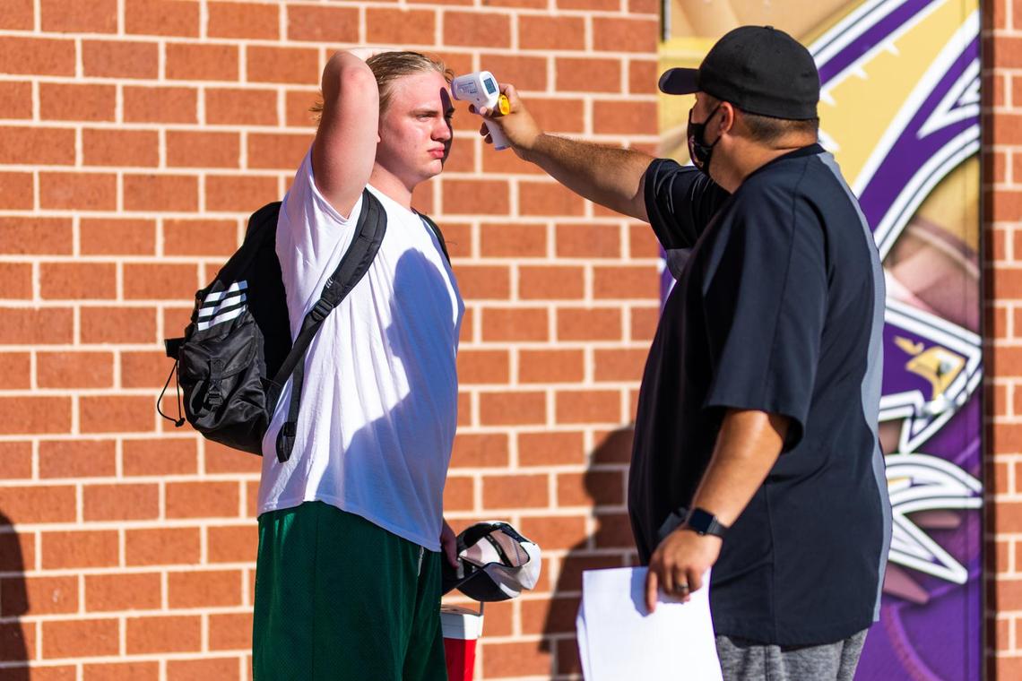 Athletes are screened for a fever before being allowed onto the field for at school workouts on June 8th, 2020, the first day of sanctioned at school workouts since the outbreak of COVID-19 in the United States. Photo: Matt Smith (Special to the Star-Telegram).