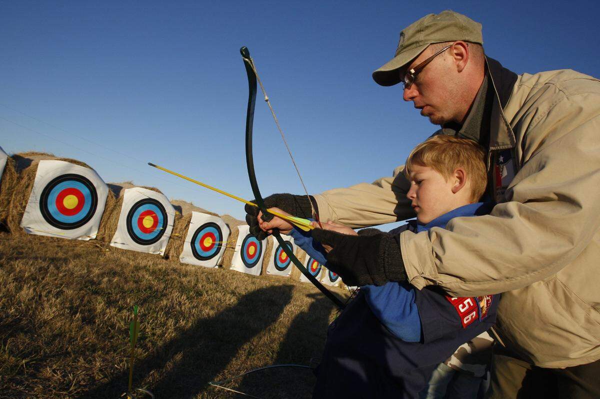 Nov. 15, 2008: Scott Broder, 7, of Cub Scout Troop 456 of Colleyville, gets help on the archery range from David Dawson, district executive of the Longhorn Council, at the Council Camporee at Texas Motor Speedway